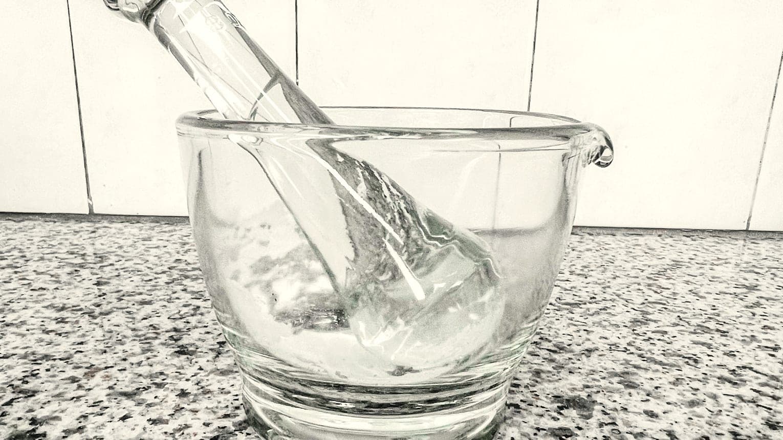 Compounding a preparation by hand with a glass mortar and pestle at Craft Pharmacy