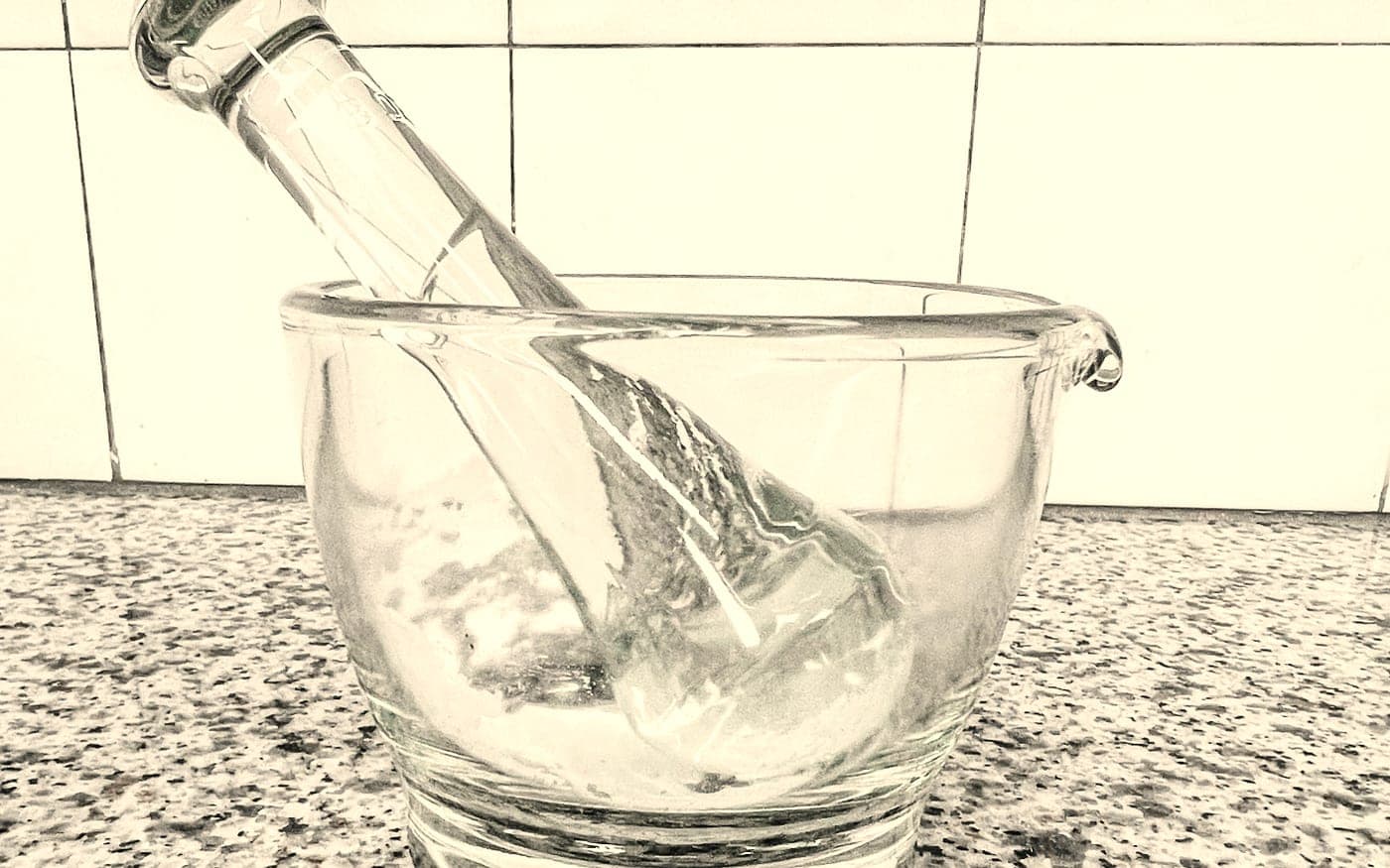 A glass mortar and pestle holding a freshly compounded cream at Craft Pharmacy
